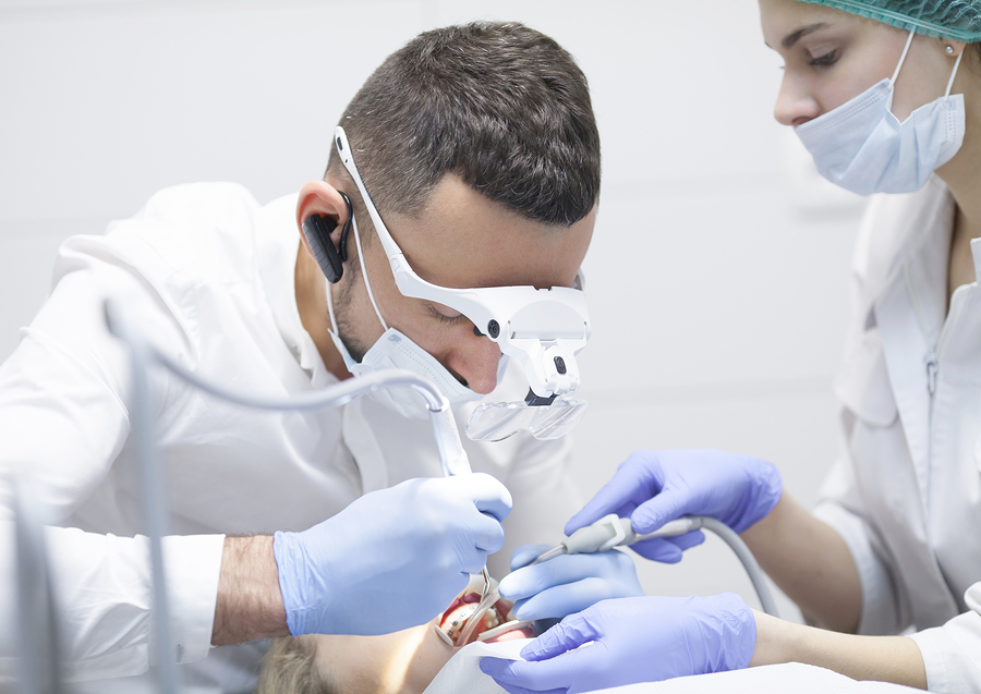 a dentist treating the teeth of a patient which might cause BMS